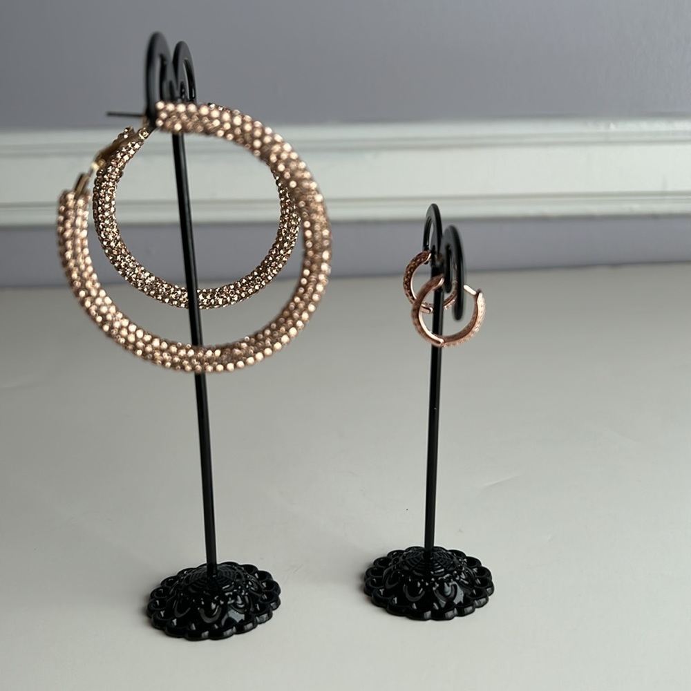 2 pair of rose gold tone sparkling earrings larger pair is from Guess